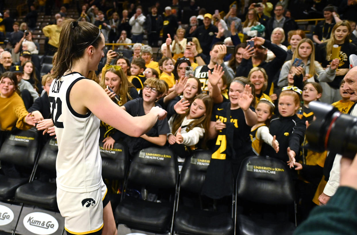 Iowa's Caitlin Clark signs autographs for fans after a regular season game. (Keith Gillett/Icon Sportswire via Getty Images)
