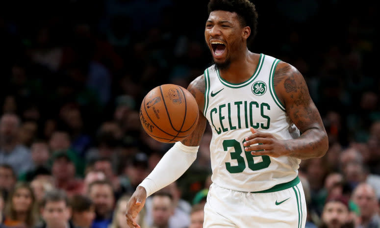 Celtics guard Marcus Smart dribbles up the ball.