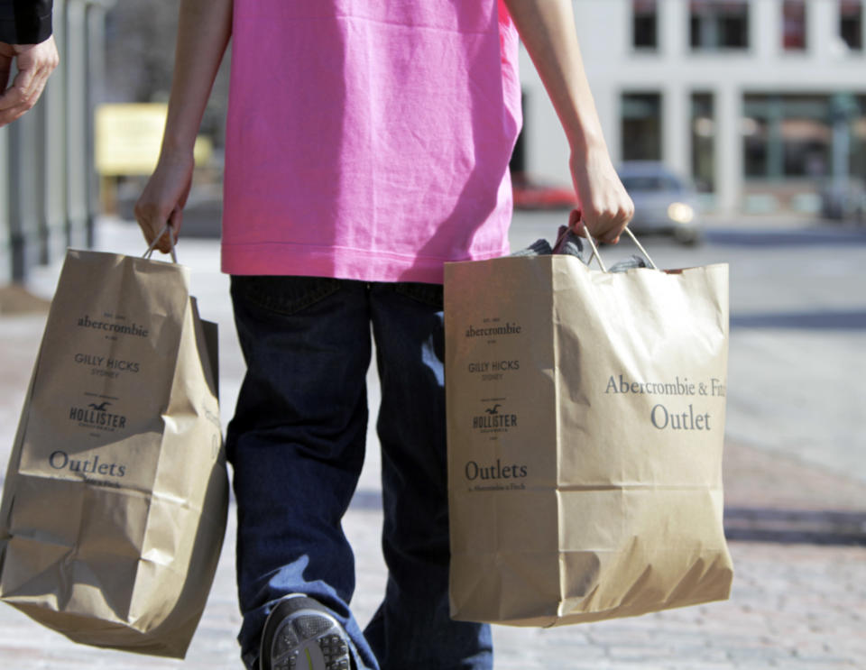 FILE - In this March 12, 2012 file photo, a shopper carries bags of merchandise in Freeport, Maine. U.S. retail sales rose at a solid pace in March 2012, as a healthier job market encouraged more consumers to shop, the Commerce Department said Monday, April 16, 2012. (AP Photo/Pat Wellenbach, File)