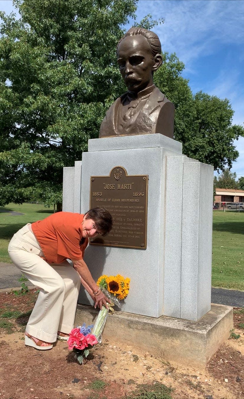 Lucie Schulz places sunflowers for Jose Marti. Lucie was part of the Jefferson County Youth Ambassador trip that resulted in the gift of the Jose Marti Bust in the summer of 1955.
