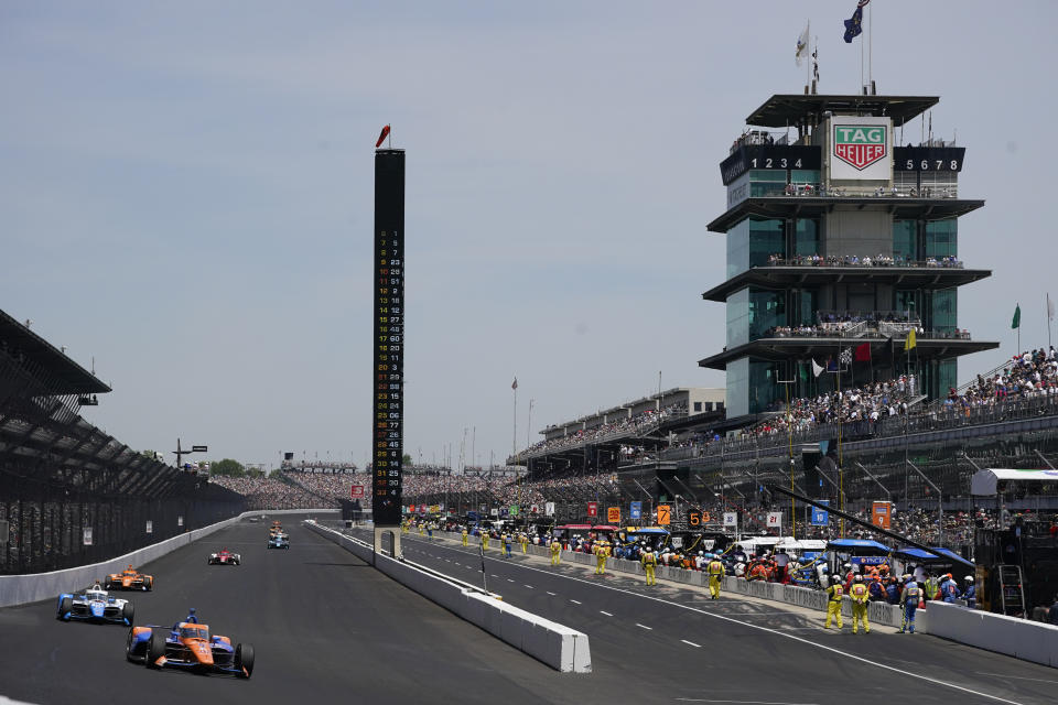 Scott Dixon, of New Zealand, leads the field into the first turn during the Indianapolis 500 auto race at Indianapolis Motor Speedway, Sunday, May 29, 2022, in Indianapolis. (AP Photo/Darron Cummings)