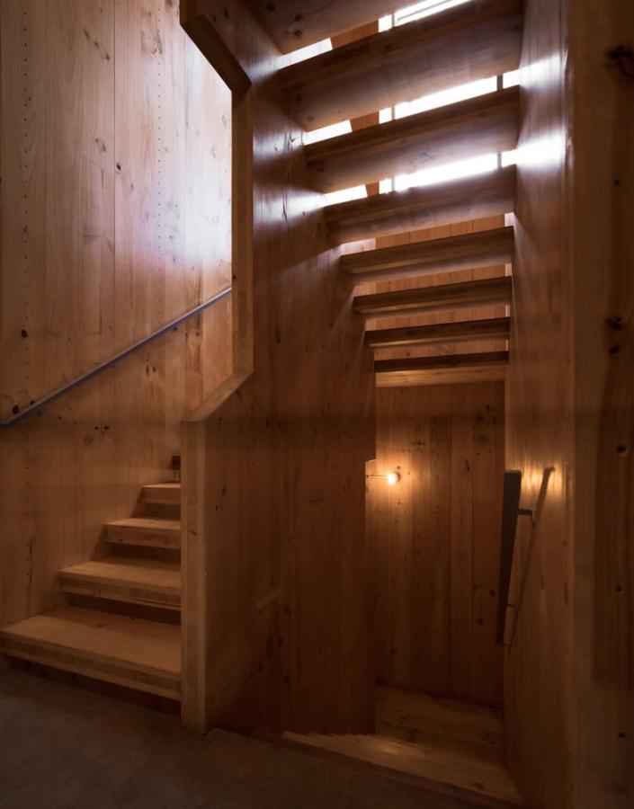 Modern wooden stairway inside the Lacol-designed La Borda housing co-op.