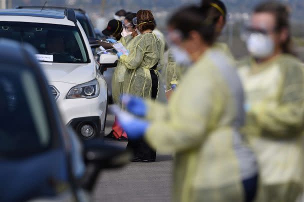 PHOTO: Medical staff from Riverside University Health Systems Hospitals (Calif.) administer a COVID-19 test at a drive-through test site in the Diamond Stadium, March 22, 2020 in Lake Elsinore, California (Bob Riha Jr/Getty Images, FILE)