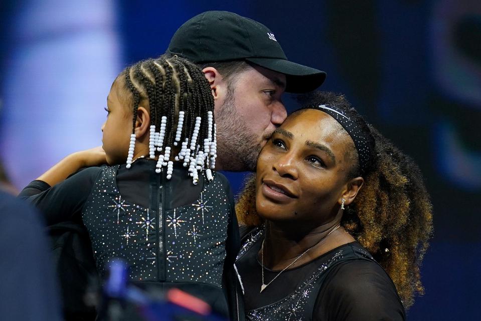 Serena Williams gets a kiss from her husband Alexis Ohanian as their daughter Olympia looks on at the 2022 U.S Open.