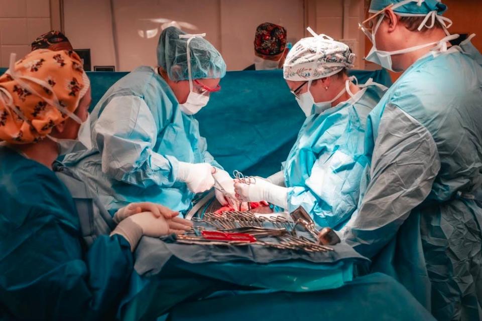 Dr. Lishman assists with a cesarean section for one of her obstetrics patients.