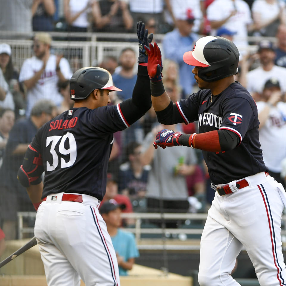 Minnesota Twins' Jorge Polanco, right, celebrates with Donovan Solano after hitting a home run against Cleveland Guardians pitcher Logan Allen during the first inning of a baseball game, Saturday, June 3, 2023, in Minneapolis. (AP Photo/Craig Lassig)