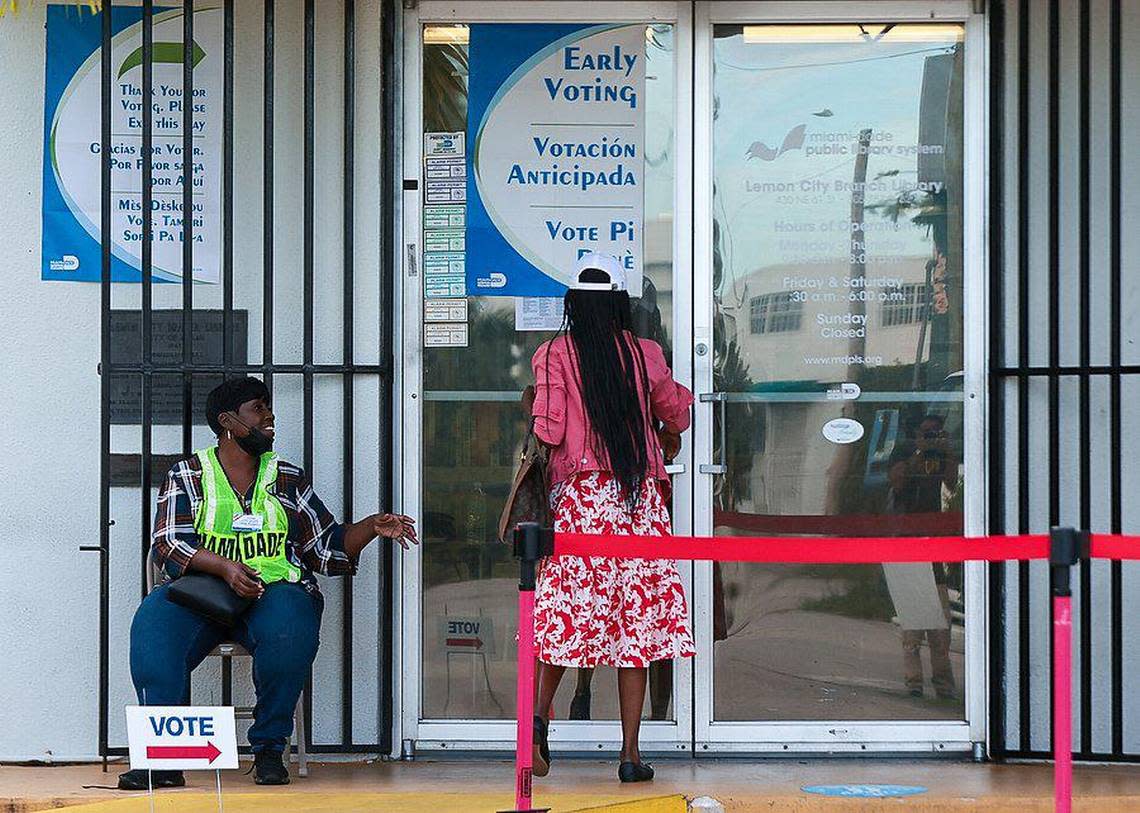 Poll worker greets voter as she enters the library to cast her vote. On Monday, October 24, 2022 Miami resident casted their vote during the first day of early voting in Miami-Dade County at the Lemon City Library in Miami, Florida.