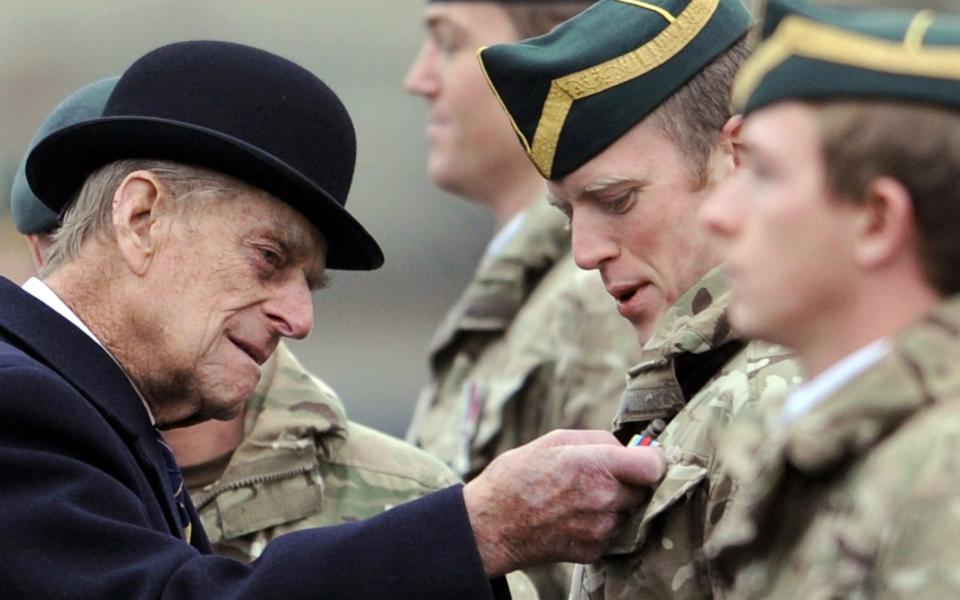 A picture dated shows Britain's Prince Philip, Duke of Edinburgh (L) visiting the tank regiment of the Queen's Royal Hussars in Paderborn, Germany, 19 November 2014 - Shutterstock