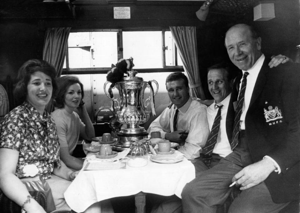 Maurice Setters (second right) with Sir Matt Busby on the train back to Manchester after winning the 1963 FA Cup.