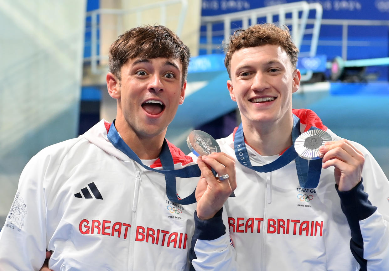 PARIS, FRANCE - JULY 29: Tom Daley of Great Britain reacts in shock after a kiss from team-mate Noah Williams as the pair present their silver medals after the Men’s Synchronised 10m Final on day three of the Olympic Games Paris 2024 at Aquatics Centre on July 29, 2024 in Paris, France. (Photo by Patrick Khachfe/Getty Images)