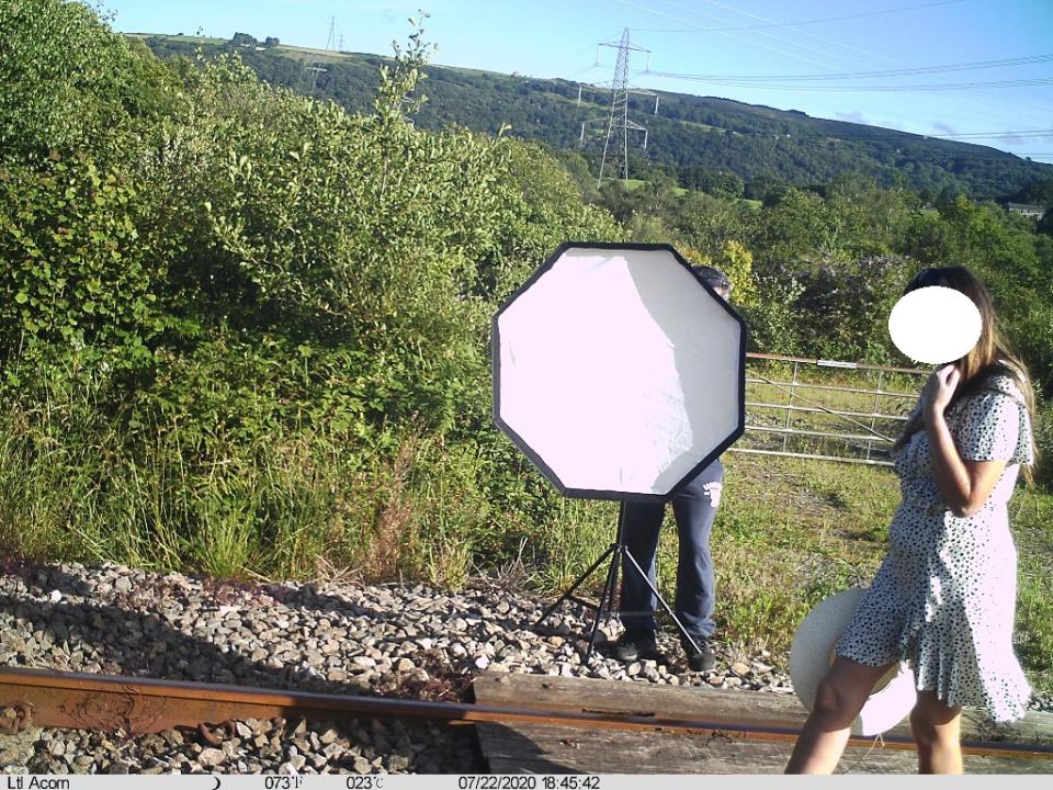 A woman poses for a photoshoot on railway tracks in Cilfrew, Wales. (Network Rail)