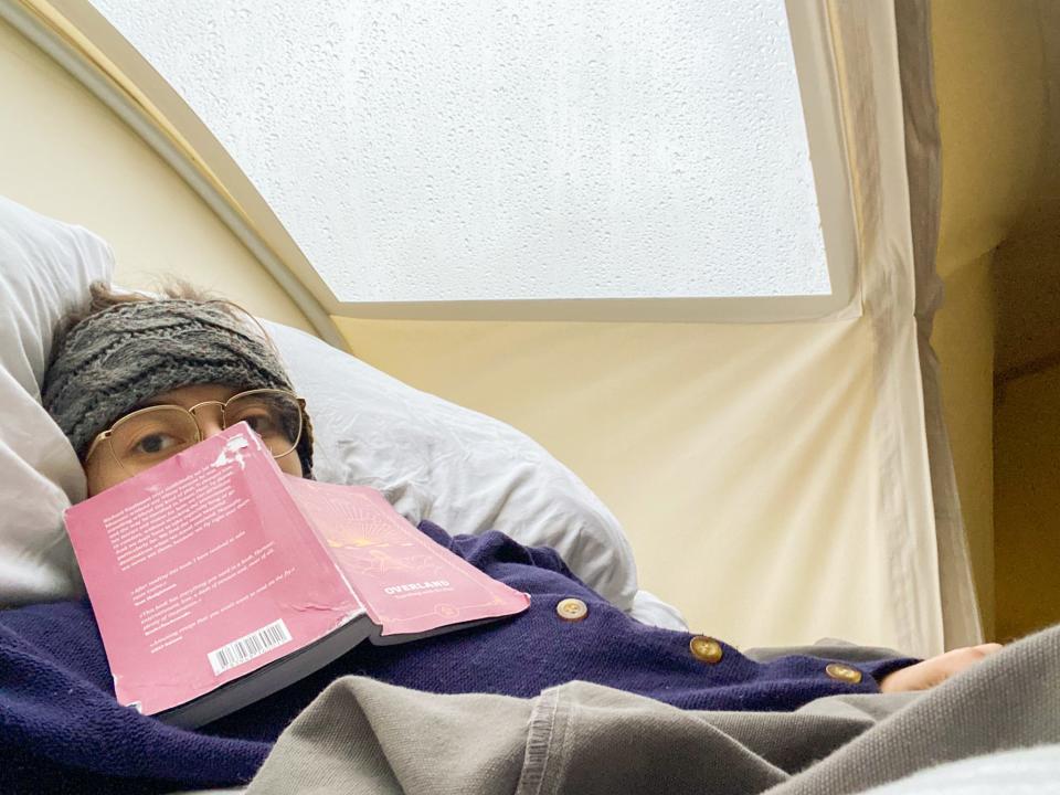 The author spends time reading in her tent at Great Smoky Mountains National Park.