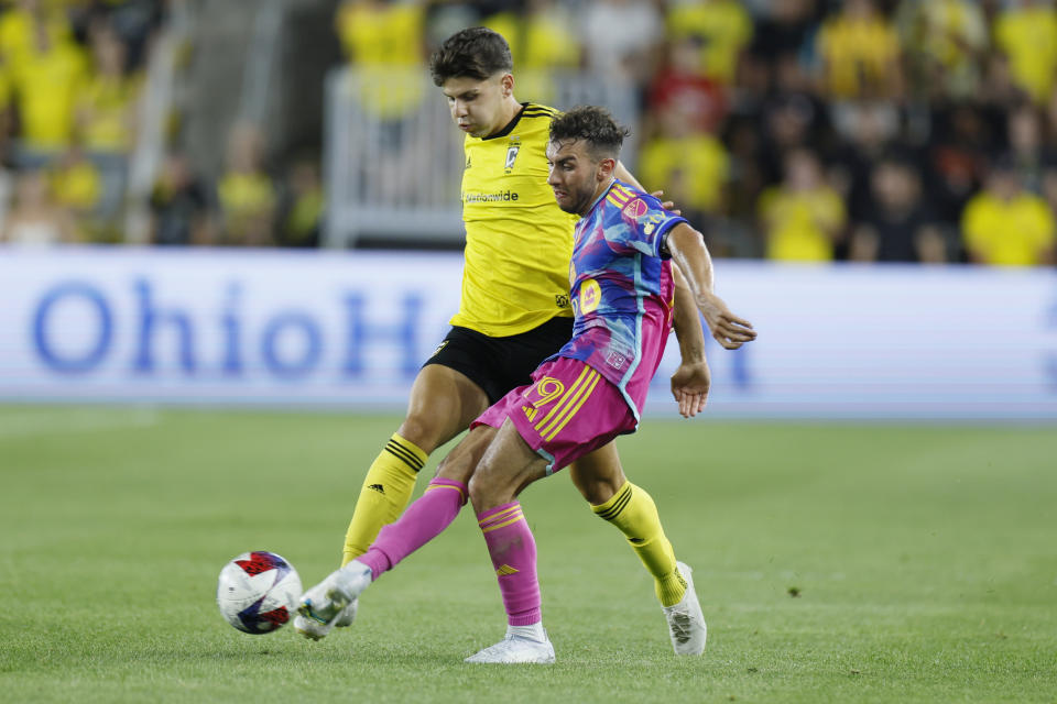 Columbus Crew's Maximilian Arfsten, left, and Toronto FC's Kobe Franklin chase the ball during the second half of an MLS soccer match Saturday, Aug. 26, 2023, in Columbus, Ohio. (AP Photo/Jay LaPrete)