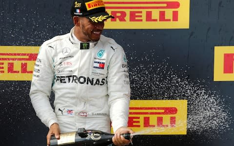 French Grand Prix - Circuit Paul Ricard, Le Castellet, France - June 24, 2018 Mercedesâ€™ Lewis Hamilton celebrates on the podium after winning the race - Credit: reuters