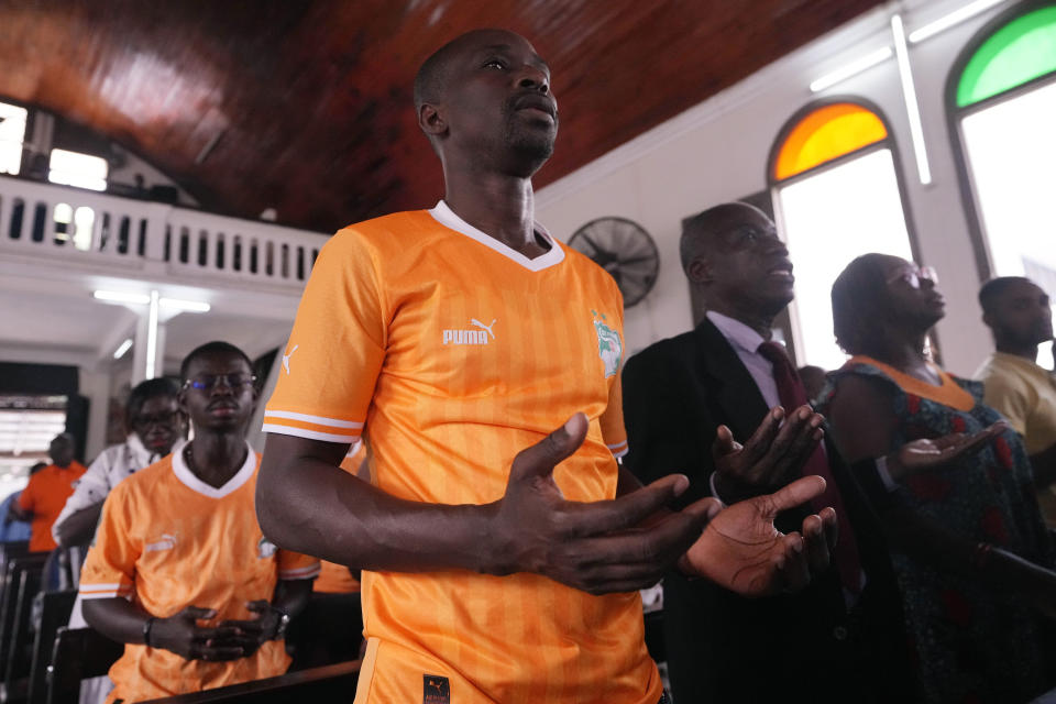 Catholic faithful pray at the Chapelle de l'Externat Saint Paul Church in Abidjan, Ivory Coast, Wednesday, Feb. 7, 2024. Ivory Coast's seemingly miraculous progression to the Africa Cup of Nations semifinals has convinced locals that God is on their side. The host nation has survived several close shaves with elimination thanks to fortune with results in other games and scarcely believable comebacks. (AP Photo/Sunday Alamba)