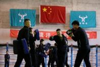 Trainees from Dewei Security attend boxing training at a training camp, on the outskirts of Beijing, China March 2, 2017. Picture taken March 2, 2017. To match Analysis CHINA-SILKROAD/SECURITY REUTERS/Jason Lee