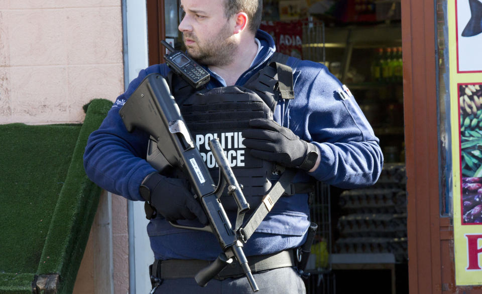 Belgian police surround the building where the gunman was reportedly holed up. (PA)