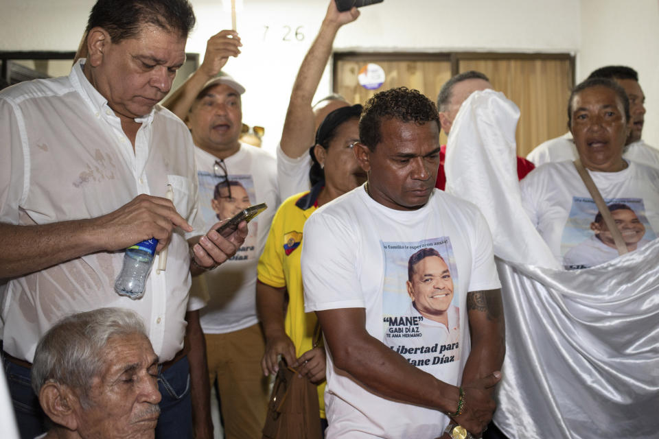 Gabriel Díaz, center, uncle of Liverpool striker, Luis Diaz, and other family members, attend a vigil for the release of the soccer star´s father, in Barrancas, La Guajira department, Colombia, Tuesday, Oct. 31, 2023. The parents of the 26-year-old Diaz were reportedly kidnapped as they drove to their home. Cilenis Marulanda, mother of the Colombian soccer player, was rescued by police in Barrancas, Colombia’s President Gustavo Petro said. (AP Photo/Leo Carrillo)