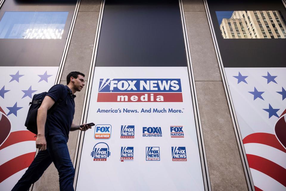 A person walks past the Fox News headquarters in New York on Wednesday, April 12, 2023.