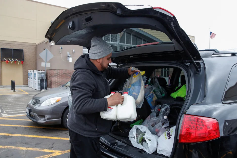 A customer puts groceries back to his car after shopping at a Walmart store in Chicago, Illinois, on November 27, 2019. REUTERS/Kamil Krzaczynski