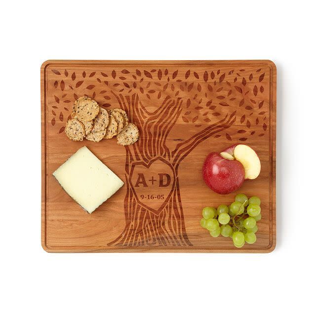 <p>uncommongoods.com</p><p><strong>$85.00</strong></p><p>Show some love to a newly married couple with a customizable serving board. They'll love the touch of personalization on something that you'll see every time you go over for dinner. </p>