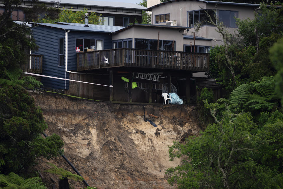 A landslip caused by flood water undermines a house in Auckland, Saturday, Jan. 28, 2023. Record levels of rainfall pounded New Zealand's largest city, causing widespread disruption. (Hadyen Woodward/New Zealand Herald via AP)