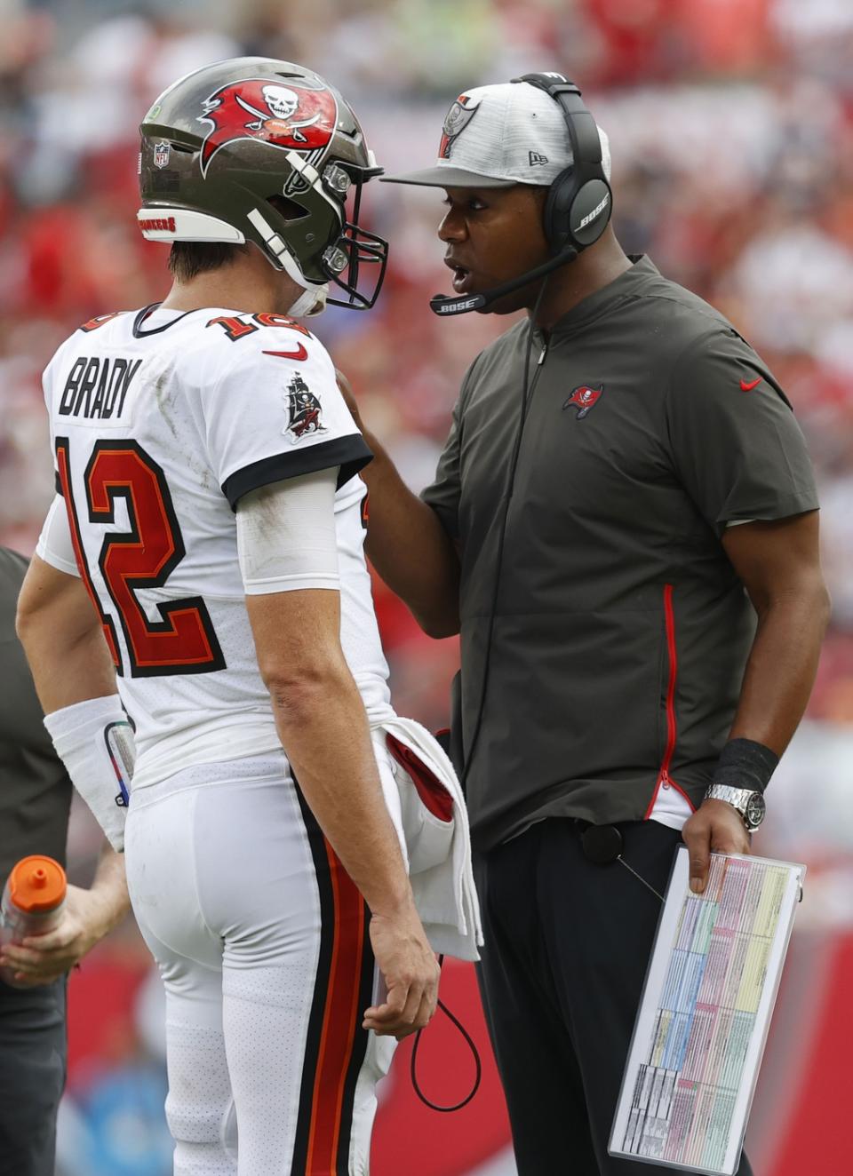 Sep 19, 2021; Tampa, Florida, USA; Tampa Bay Buccaneers quarterback Tom Brady (12) talks with offensive coordinator Byron Leftwich during the first half at Raymond James Stadium. Mandatory Credit: Kim Klement-USA TODAY Sports