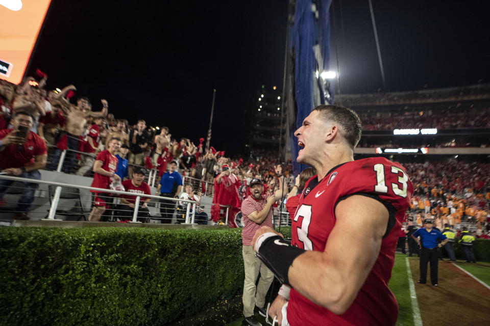 Georgia quarterback Stetson Bennett (13) reacts to the crowd as he leaves the field following Georgia's victory over Tennessee in an NCAA college football game Saturday, Nov. 5, 2022 in Athens, Ga. (AP Photo/John Bazemore)