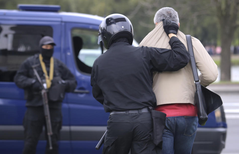 Police detain a man during an opposition rally to protest the official presidential election results in Minsk, Belarus, Sunday, Sept. 27, 2020. Tens of thousands of demonstrators marched in the Belarusian capital calling for the authoritarian president's ouster, some wearing cardboard crowns to ridicule him, on Sunday as the protests that have rocked the country marked their 50th consecutive day. (AP Photo/TUT.by)