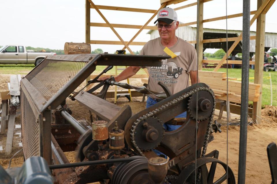 Anthony Hehl of LaSalle makes walking sticks on a duplicating lathe May 20, 2022 at the Farmers Antique Tractor & Engine Association's spring show.