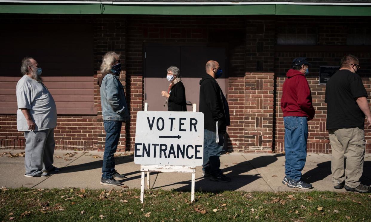 <span>Voters wait in line outside a polling center on election day in Kenosha, Wisconsin, on 3 November 2020.</span><span>Photograph: Wong Maye-E/AP</span>