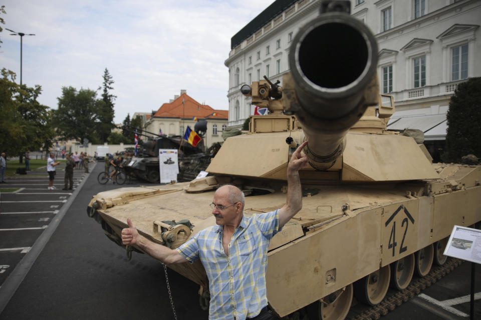 People attend a military picnic marking the Polish Army Day in Warsaw, Poland, Monday, Aug. 15, 2022. The Polish president and other officials marked their nation's Armed Forces Day holiday Monday alongside the U.S. army commander in Europe and regular American troops, a symbolic underlining of NATO support for members on the eastern front as Russia wages war nearby in Ukraine. (AP Photo/Michal Dyjuk)