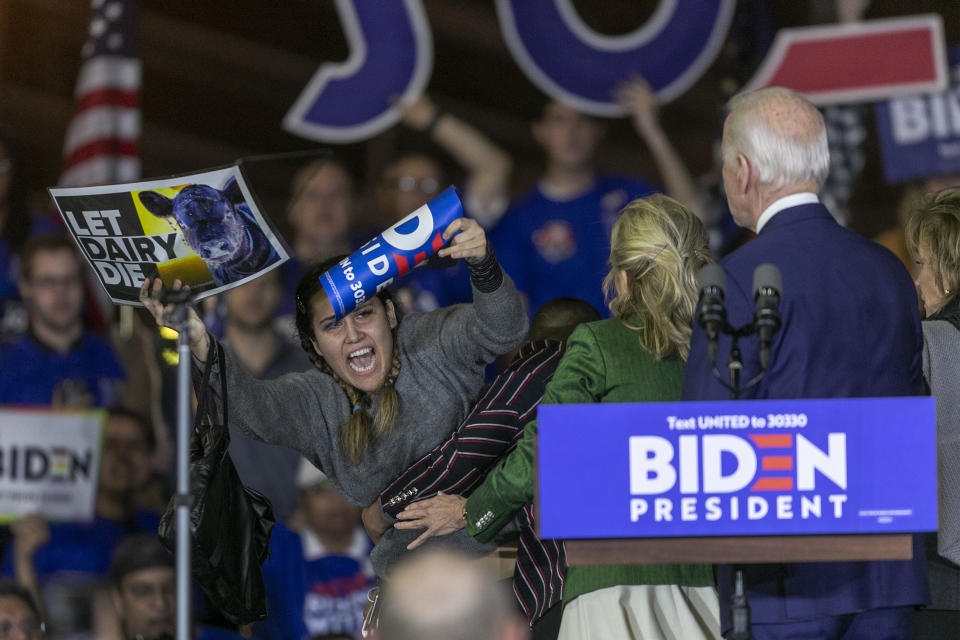 LOS ANGELES, CA - MARCH 03:  A woman charges the stage while holding a sign that reads "Let Dairy Die" as Democratic presidential candidate former Vice President Joe Biden speaks at a Super Tuesday event at Baldwin Hills Recreation Center on March 3, 2020 in Los Angeles, California. Biden is hoping his make-or-break victory in the South Carolina primary has influenced Super Tuesday voters to lean toward him. (Photo by David McNew/Getty Images)