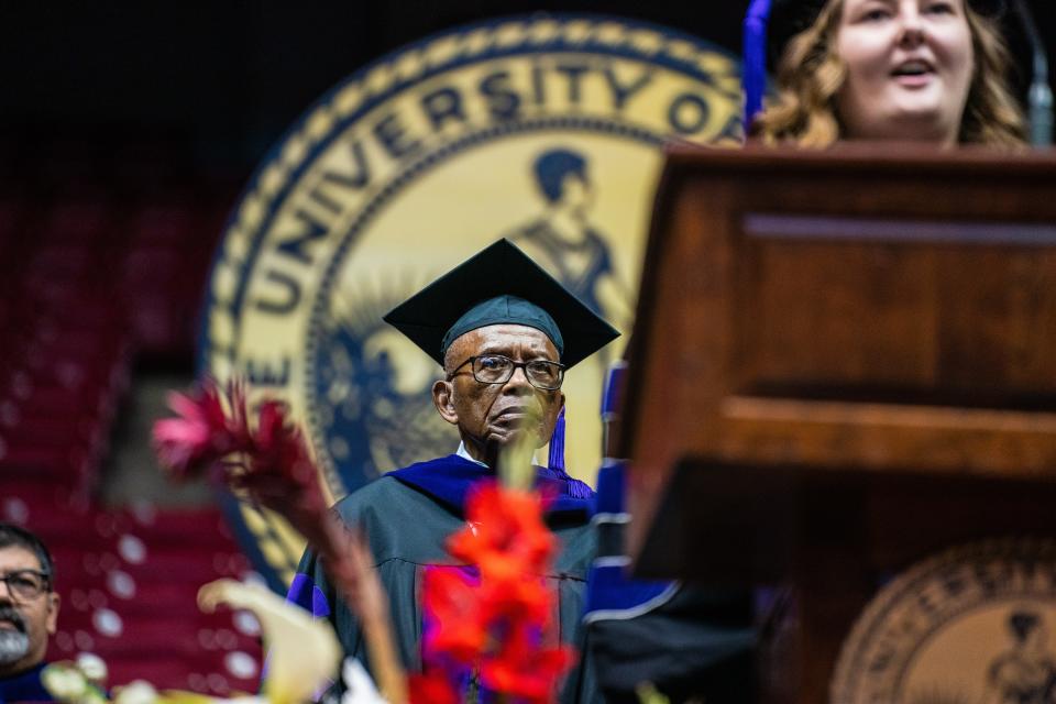 Civil rights lawyer Fred Gray stands and listens as a graduate sings the national anthem at the start of the University of Alabama School of Law graduation ceremony at Coleman Coliseum, Sunday May 8, 2022. [Photo/Will McLelland]