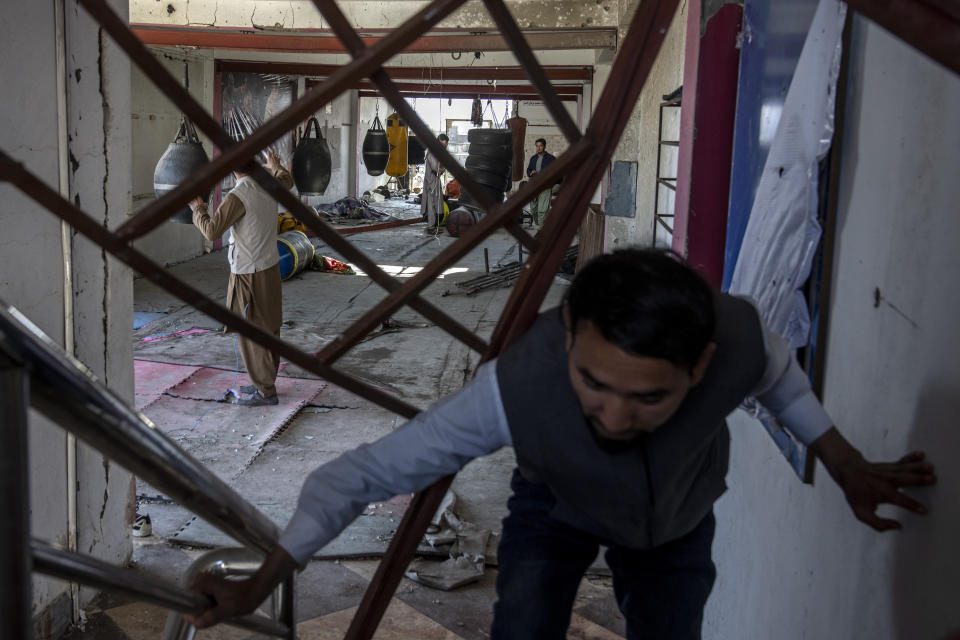 Afghan men remove the site of the explosion in a sports club, in the west of Kabul, Afghanistan, Friday, Oct. 27, 2023. The blast killed some people and injured others in a Shiite neighbourhood in the Afghan capital Kabul. (AP Photo/Ebrahim Noroozi)