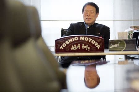 APA Group CEO Motoya Toshio poses for pictures after an interview at the hotel group's headquarters in Tokyo April 17, 2015. REUTERS/Thomas Peter