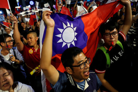 Supporters of Opposition Nationalist Kuomintang Party (KMT) Kaohsiung mayoral candidate Han Kuo-yu celebrate after Han won the local elections, in Kaohsiung, Taiwan November 24, 2018. REUTERS/Tyrone Siu