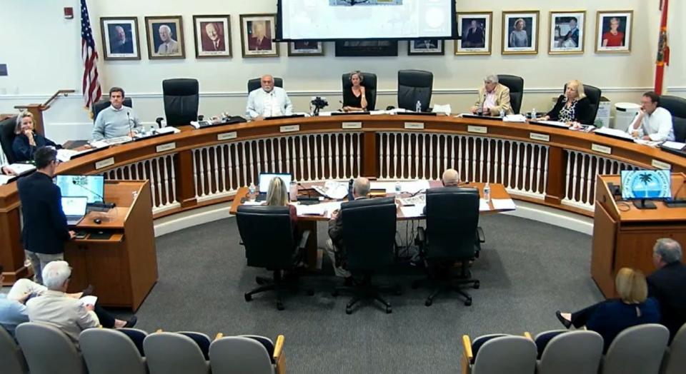 Rob Frisbie Jr., at the left podium, addresses the Palm Beach Planning and Zoning Commission on March 5 regarding a major residential project Frisbie Group proposed to redevelop at the historic Wells Fargo Bank property on South County Road at Royal Palm Way in Palm Beach.