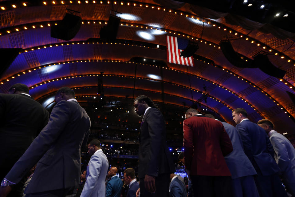 Jadeveon Clowney, center, from South Carolina, walks off stage after standing for a group photo with fellow draft prospects before the first round of the NFL football draft, Thursday, May 8, 2014, at Radio City Music Hall in New York. (AP Photo/Jason DeCrow)