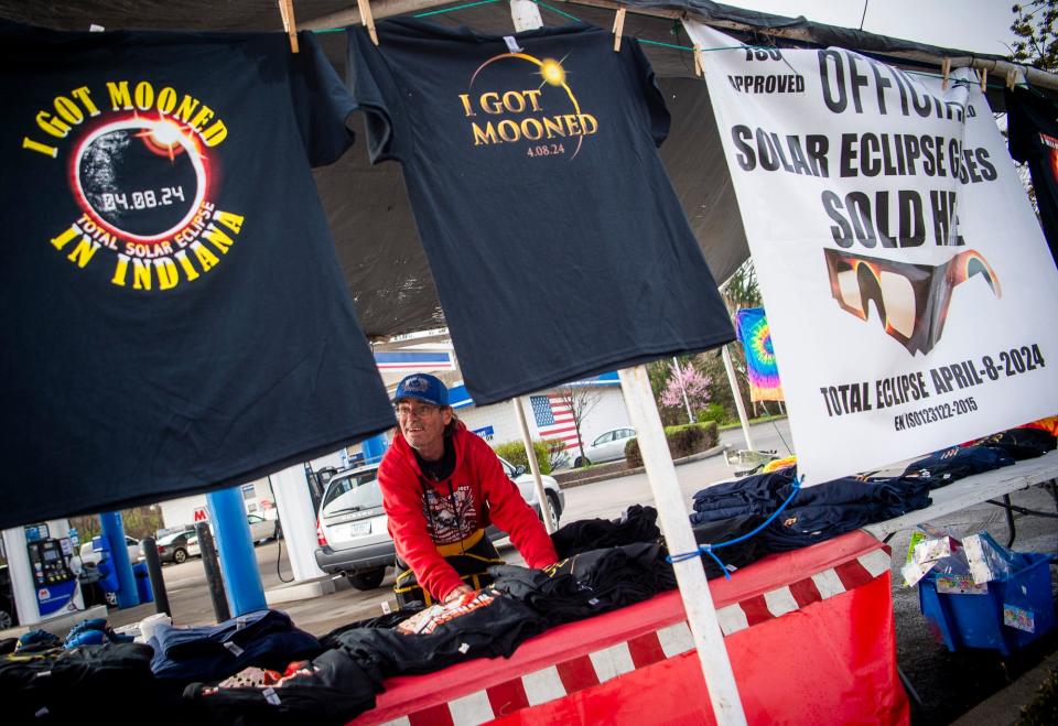 Virgil Craig sells eclipse merchandise outside of the Marathon Station on South Walnut Street on the morning of April 8, 2024. The tee shirts are $25 each.