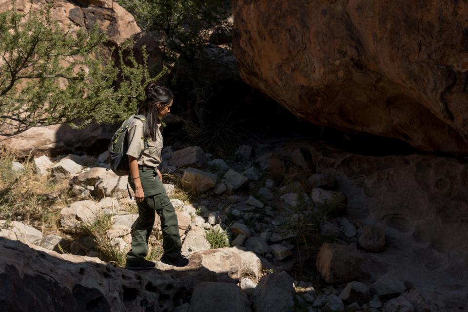 Hueco Tanks State Park ranger Nicole Roque, 32, walks through Hueco Tanks State Park in El Paso County, Texas, on Friday, June 29, 2022.