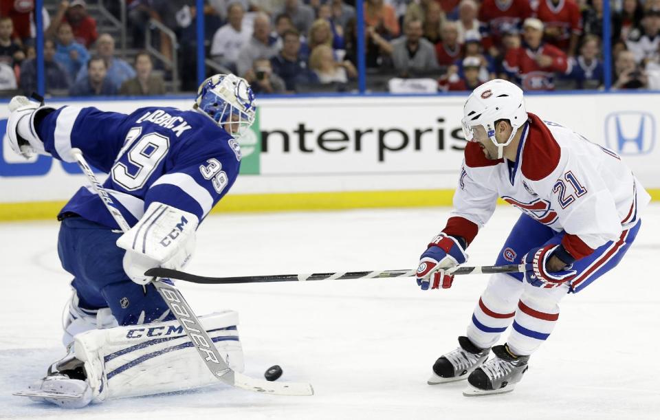 Tampa Bay Lightning goalie Anders Lindback (39), of Sweden, stops a breakaway by Montreal Canadiens right wing Brian Gionta (21) during the first period of Game 2 of a first-round NHL hockey playoff series on Friday, April 18, 2014, in Tampa, Fla. (AP Photo/Chris O'Meara)