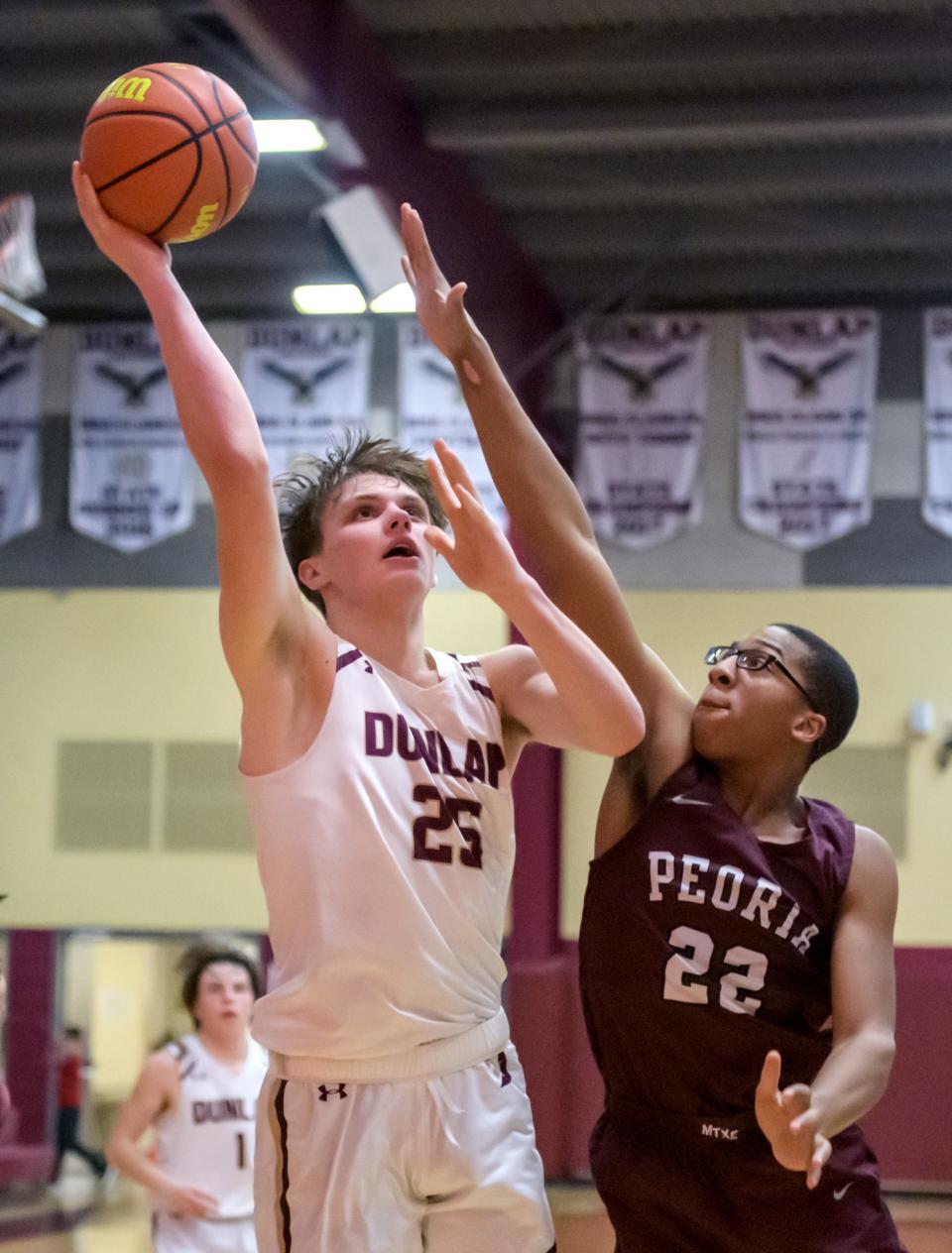 Dunlap's Mack Sutter (25) shoots over Peoria High's Deronnie Pearson in the second half Tuesday, Jan. 17, 2023 at Dunlap High School. The Lions defeated the Eagles 71-46.