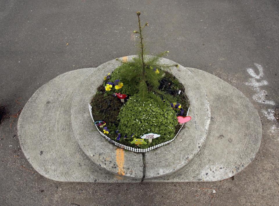 Mill Ends Park sports a myriad of colorful decorations in Portland, Ore., Thursday, April 11, 2013. Tiny battle lines are being drawn in a whimsical British-American dispute over which country has the world’s smallest park. Two feet in diameter, Portland’s Mill Ends Park holds the title of world’s smallest park in the Guinness Book of World Records. But a rival has emerged--Prince’s Park, more than 5,000 miles away in the English town of Burntwood which holds the record for smallest park in the United Kingdom.(AP Photo/Don Ryan)