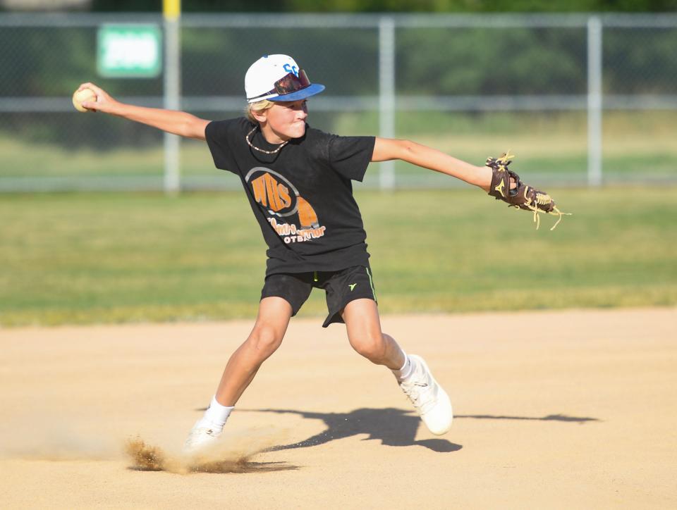 Dawson Barck (#6) throws a ball to first base during Little League practice on Monday, August 1, 2022, at Cherry Rock Park in Sioux Falls.