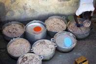 <p>A prisoner fills his lunch bowl with rice and beans at the National Penitentiary in downtown Port-au-Prince, Haiti, Feb. 13, 2017. Overcrowding, malnutrition and infectious diseases that flourish in jammed quarters has led to an upsurge of inmate deaths at the National Penitentiary. (Photo: Dieu Nalio Chery/AP) </p>