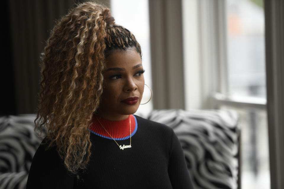 In this Jan. 18, 2019 photo, singer and TV personality Syleena Johnson poses for a photo at her home in Alpharetta, Ga. Johnson, who appeared in the reality series “R&B Divas” and co-hosts the TV One daytime talk show, “Sister Circle,” sang the 2001 song, “I Am Your Woman," which was written and produced by R. Kelly. (AP Photo/Annie Rice)