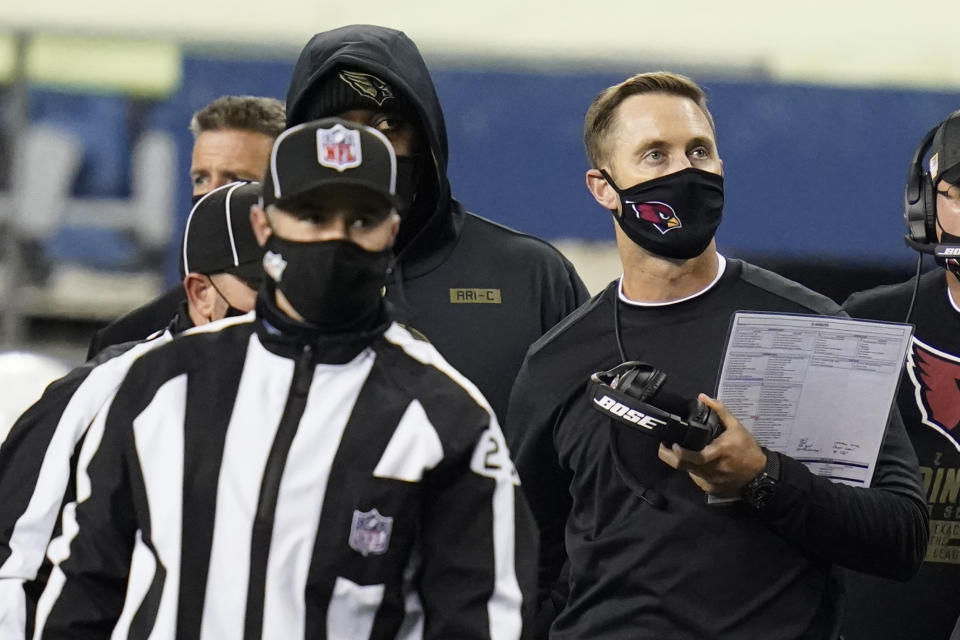 Arizona Cardinals head coach Kliff Kingsbury, right, looks toward the scoreboard during the second half of an NFL football game against the Seattle Seahawks, Thursday, Nov. 19, 2020, in Seattle. (AP Photo/Elaine Thompson)