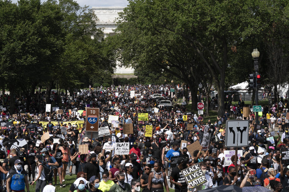 People start marching at Lincoln Memorial toward the Martin Luther King Jr. Memorial during the March on Washington, Friday Aug. 28, 2020, on the 57th anniversary of the Rev. Martin Luther King Jr.'s "I Have A Dream" speech. (AP Photo/Jose Luis Magana)