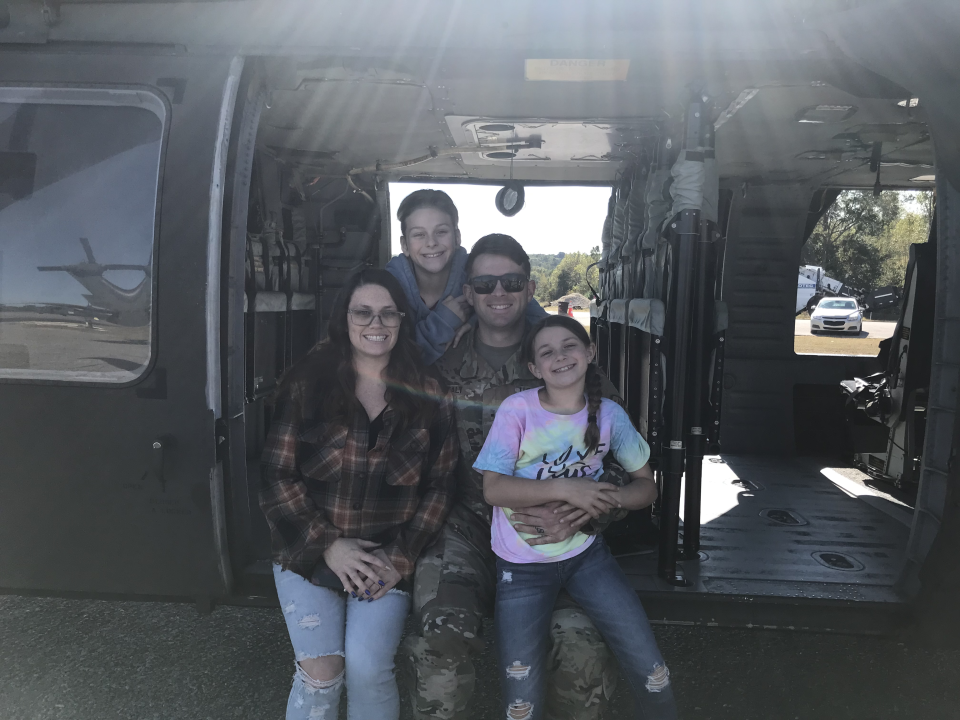 Healy, his wife and children pose in a helicopter.